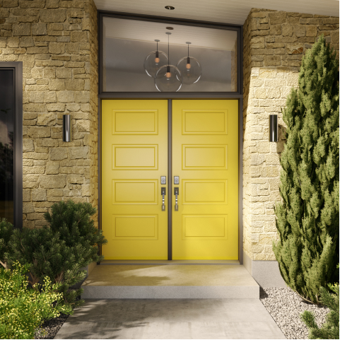 Porte d’entrée extérieure double Vaillancourt Portes et Fenêtres de couleur jaune personnalisée sur maison en pierres beiges.