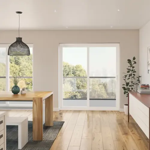 Porte-patio R-650 en PVC blanc de Vaillancourt Portes et Fenêtres, vue depuis l’intérieur d’une maison vers la salle à manger et l’extérieur.