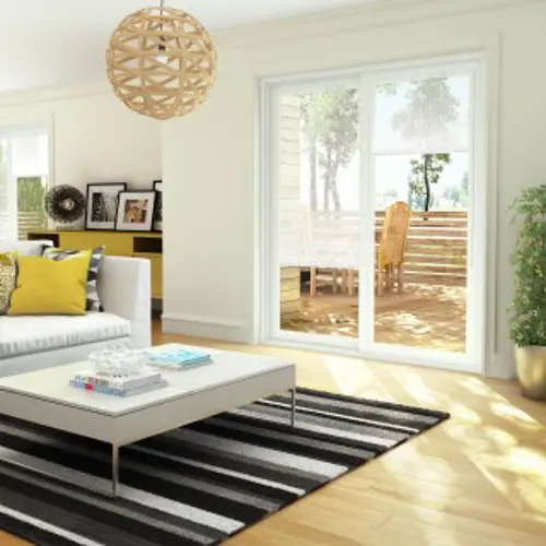 White model of the R-550 welded PVC patio door from Vaillancourt Doors and Windows, seen from the living room inside a house.