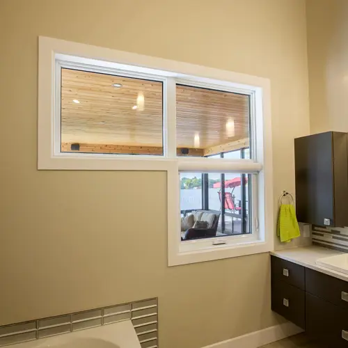 Three white Vaillancourt Doors and Windows awning windows in PVC or hybrid in a bathroom for a customized look.
