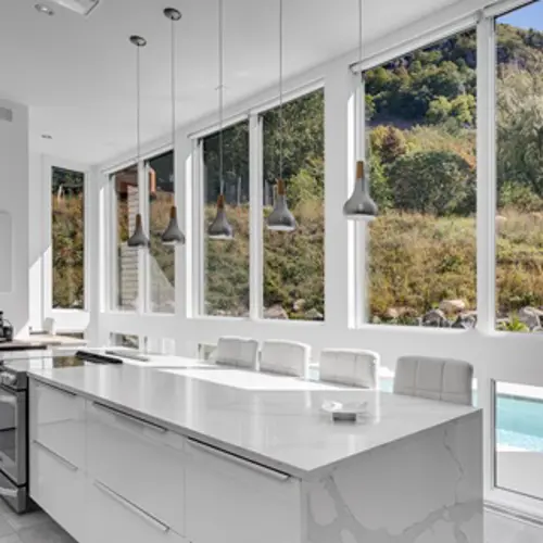 Large fixed hybrid windows from Vaillancourt Doors and Windows in a kitchen.